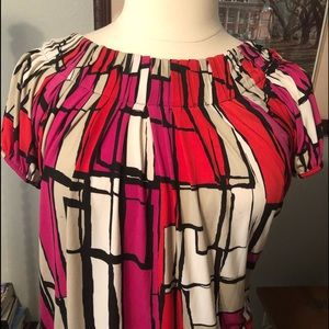 Red and tan blouse with neck ruffles